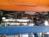 Side view of custom exhaust repair services on custom orange Jeep