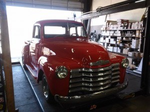 Repairs on a Red Classic Chevy Pickup